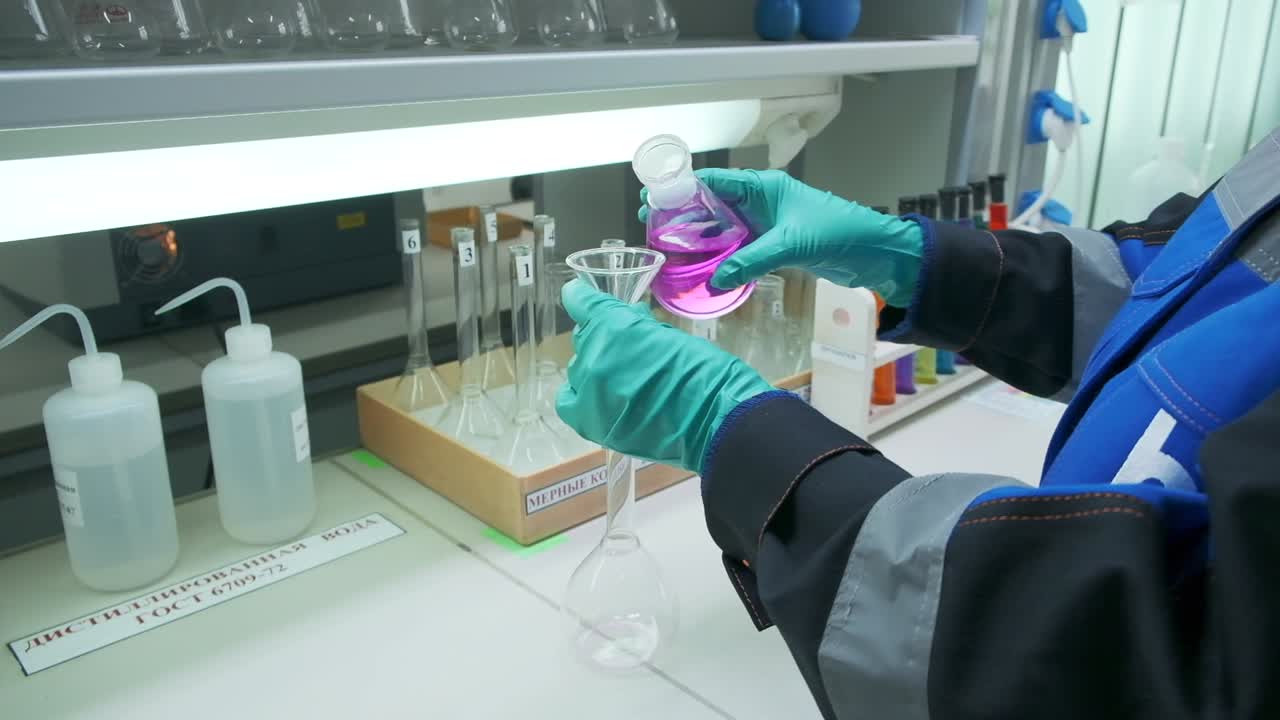 Scientist performing a chemical experiment in a laboratory.
