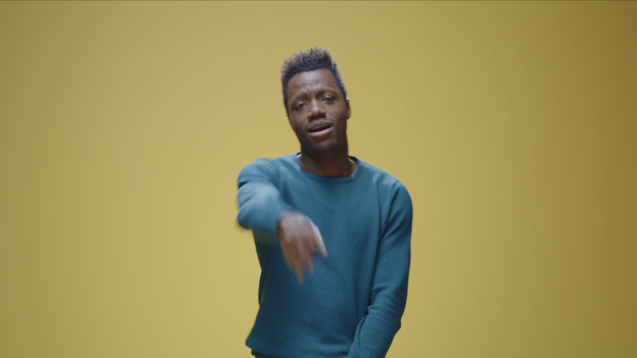Smiling Black Man Gesturing and Expressing on Yellow Background