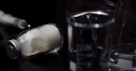 Laboratory Equipement: Syringe And Medicine Test Tubes And Flasks Rotating On Black Background 4