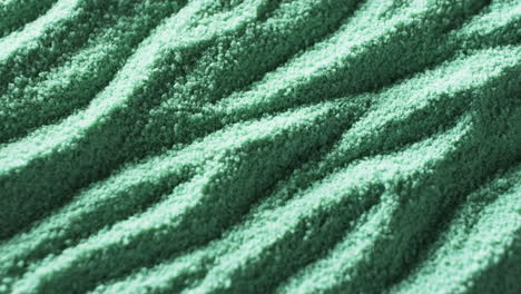 Close-up-of-a-textured-green-fabric-with-a-wavy-pattern