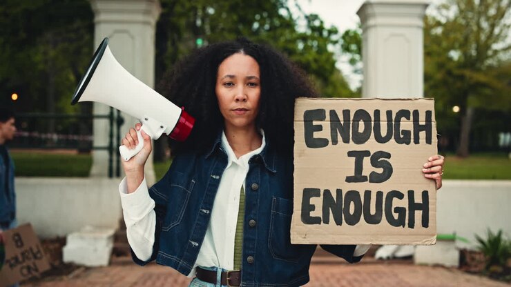 Activist Woman Holds Megaphone and 'Enough Is Enough' Protest Sign