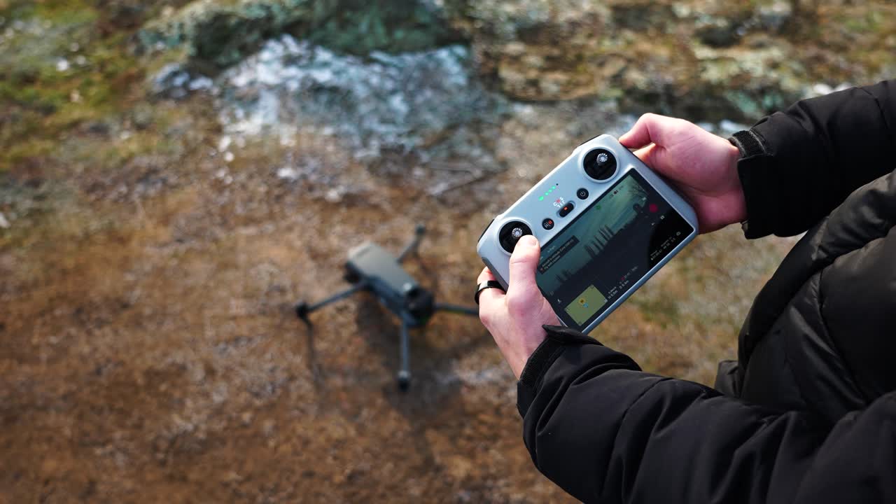 Person make remote control joystick combination and activate drone propellers