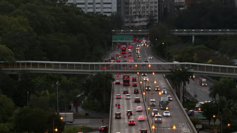 Heavy-Traffic-Under-Footbridge-in-Hong-Kong,-Aerial-Wide-Angle-Shot