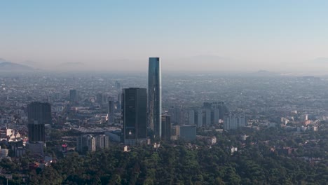 drone footage of skyscrapers in southern mexico city, showing city shrouded in smog
