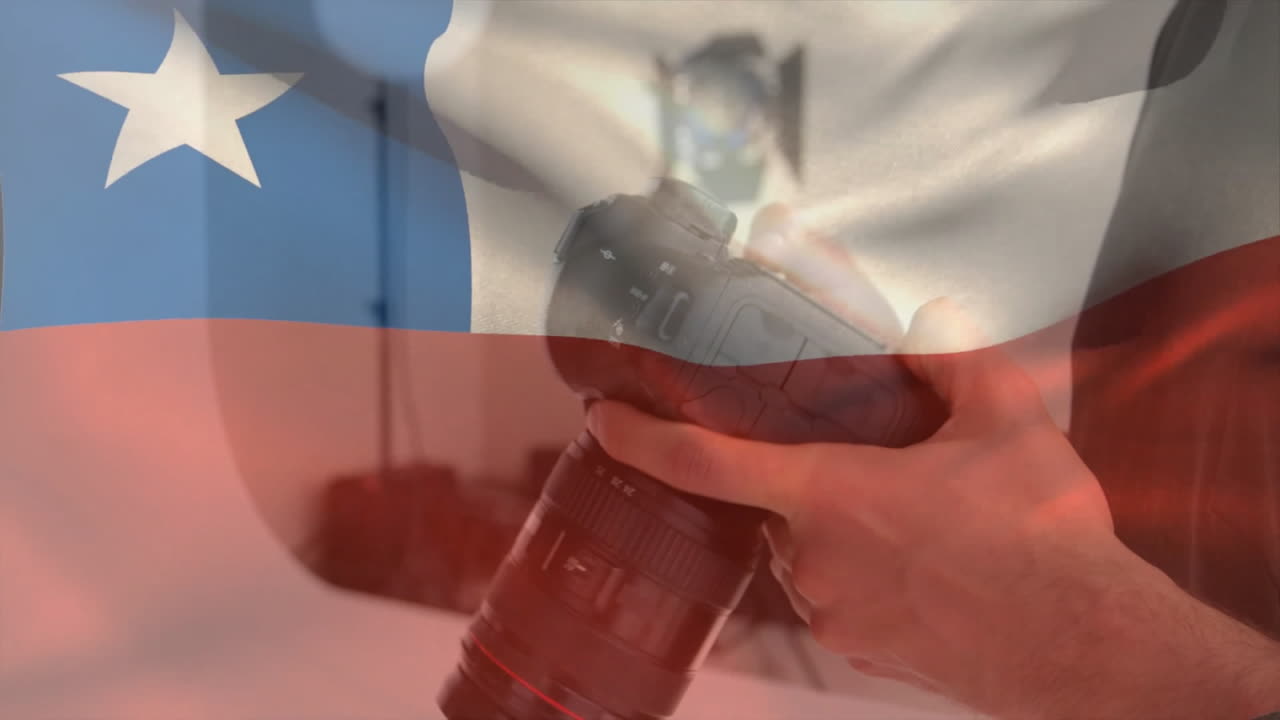 Holding camera over Chilean flag, hands capturing photography and national pride