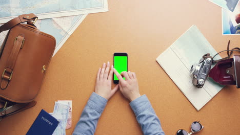 top view woman traveler hands planning holiday using mobile phone app vintage desk from above - red epic dragon