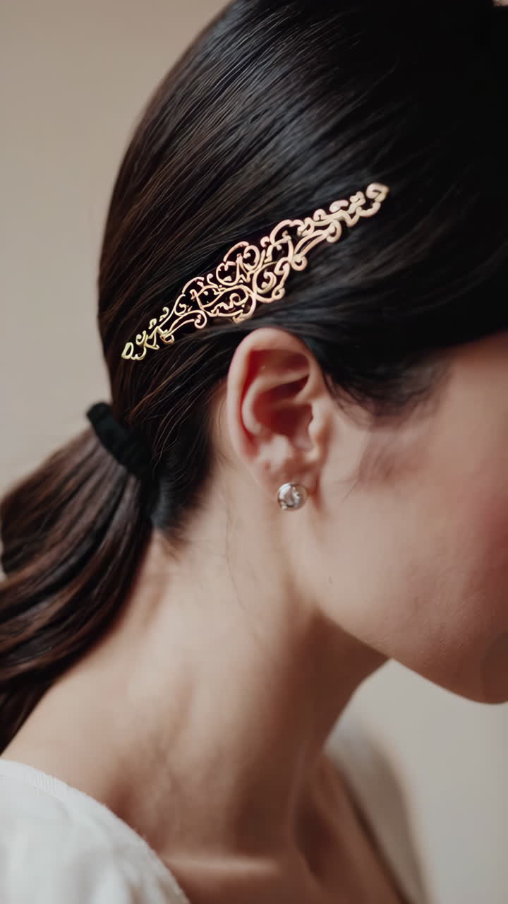 Close-up of a Woman's Hair with an Ornate Golden Hair Clip and Earring