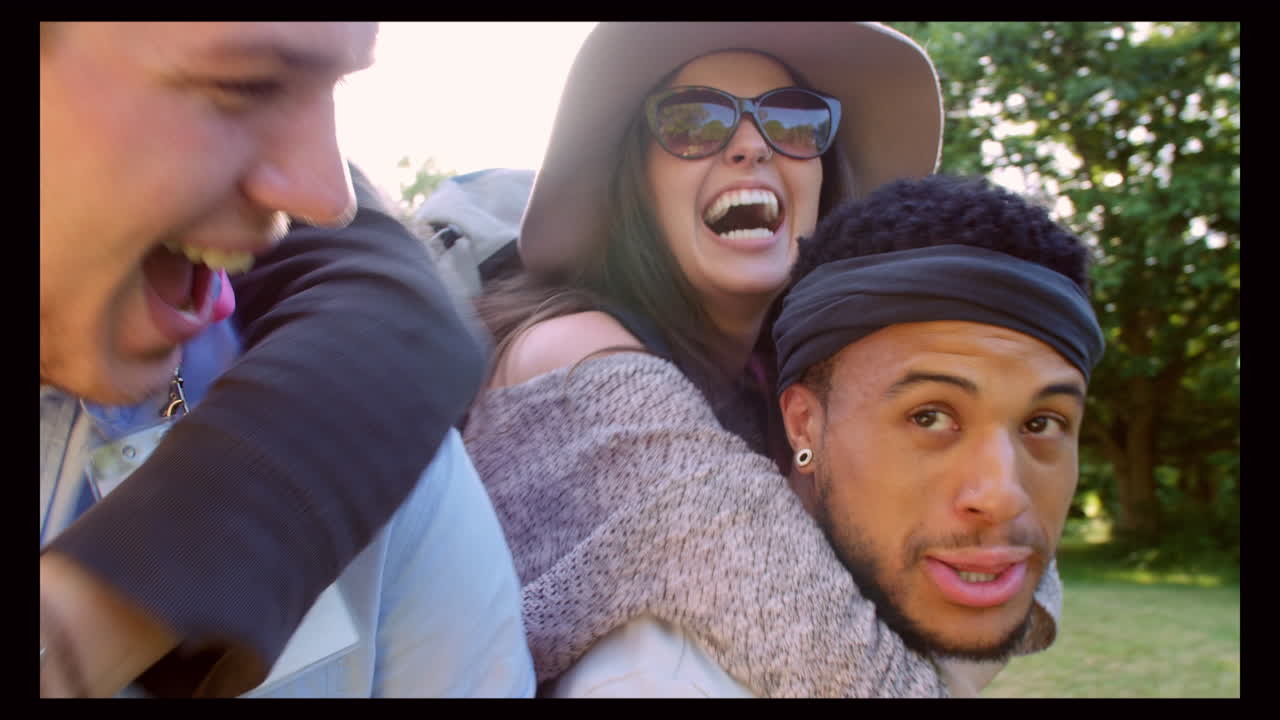 Men Giving Woman Piggybacks On Their Way To Music Festival