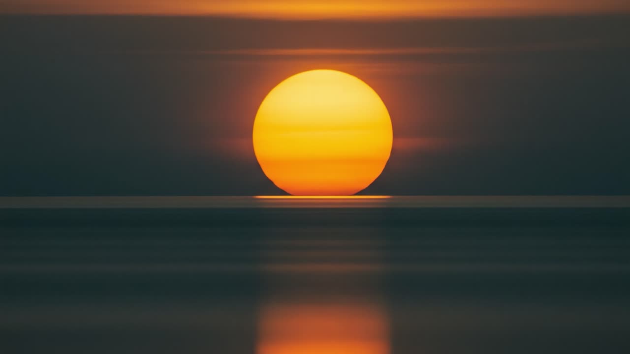 A Stunning Sunset Over Calm Waters: Capturing the Tranquil Beauty of Reflection and Warmth in Nature's Evening Canvas