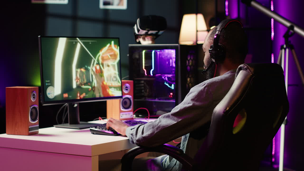 Gamer celebrating winning online multiplayer videogame, pumping fists in air