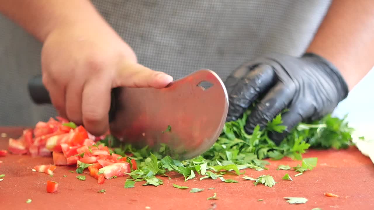 Chef Chopping Fresh Parsley and Vegetables