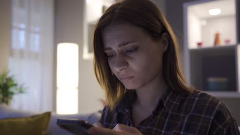 crying woman texting on the phone.