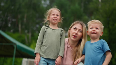 woman points ahead showing children thing at forest resort