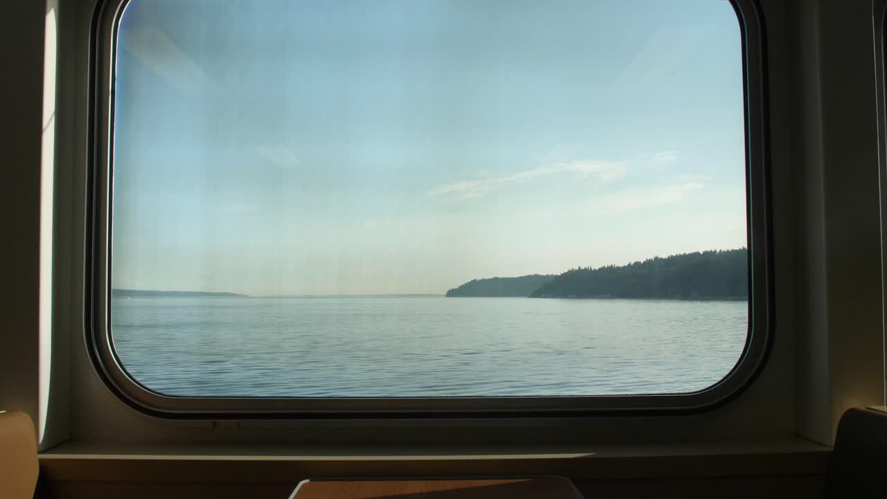 View out of a commuter's ferry in the PNW with an empty booth