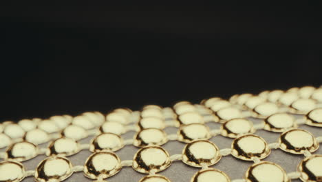 close-up of gold beads on fabric