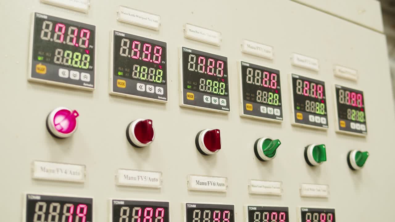 Craft beer production factory, brewery manufacture. Putting barley malt grains in conveyor close-up. Brewing, cooking alcohol in metal vats bottles