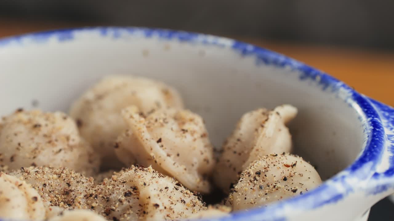 A bowl of delicious dumplings with pepper