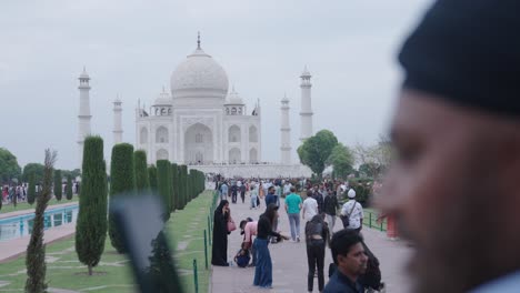 indian man clicking pictures of taj mahal