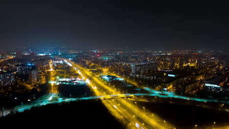 aerial view of a city at night with highway intersections
