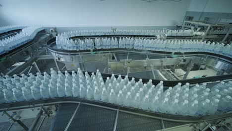 conveyor belt with bottles of drinking water at a modern beverage plant