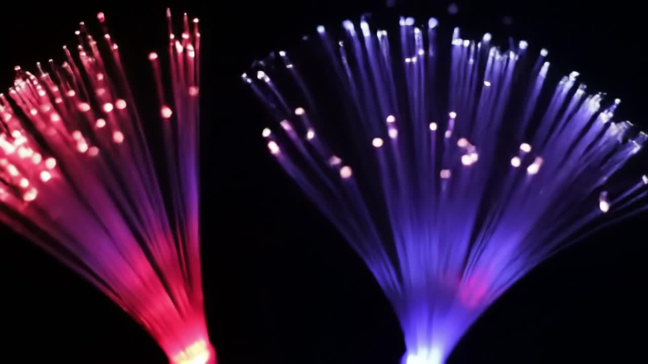 Vibrant fiber optic lights in red and blue create a captivating ambiance by illuminating the dark surroundings.
