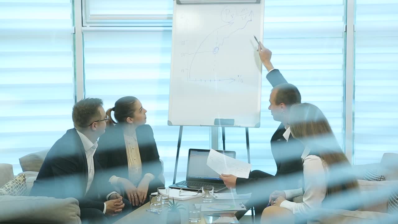 Corporate Communication Teamwork Concept. Business people working in conference room, view through the blinds on the window