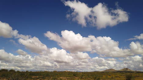 low cumulus white clouds form over mojave desert, timelapse