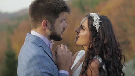 groom with bride on a mountain hills in the forest. wedding couple