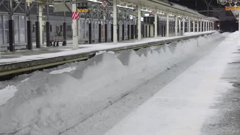 snow fall covering jr aomori train station in northern japan, winter scene