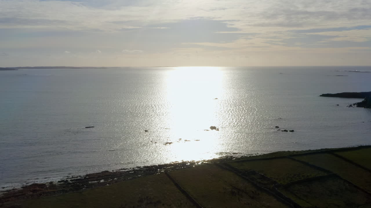 Aerial pullback over Clifden Bay, revealing a vast and tranquil Connemara seascape.