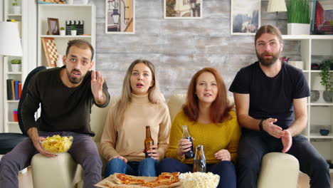 excited friends sitting on couch cheering up