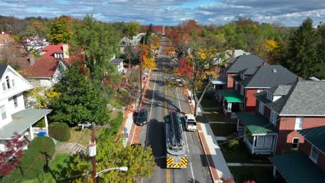 fire truck driving in usa town during autumn