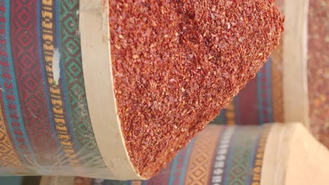 dried red pepper flakes in a traditional spice container