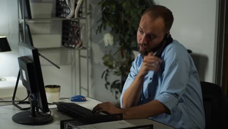 male office worker, working late