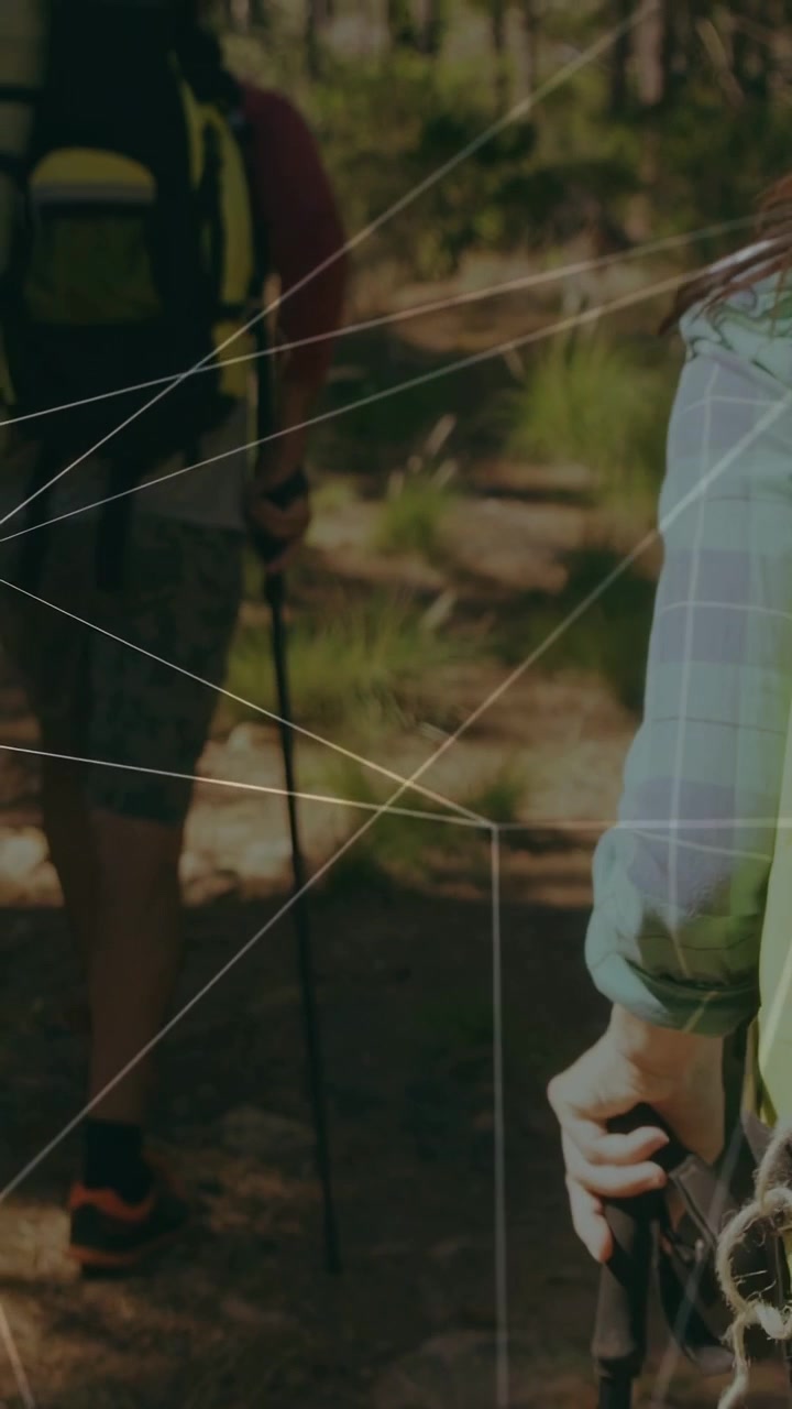 Vertical video: Rear hiker stepping, camera pulling back, white lines showing pack for outdoor gear