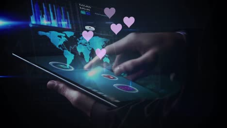 animation of hearts floating over hands of caucasian man using tablet with world map and graphs