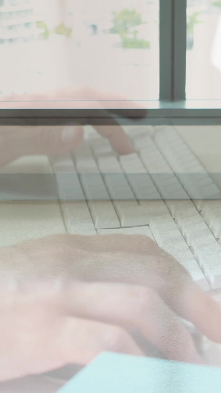 Animation of hands using laptop over male and female colleague walking in modern building