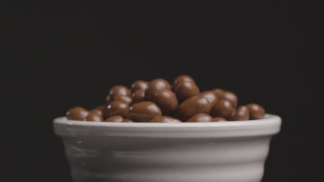 disparo deslizante acercándose al cuenco de cacahuetes cubiertos de chocolate