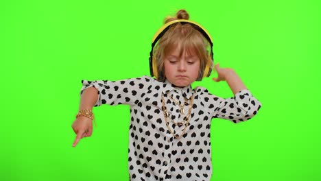 Funny-playful-blonde-child-kid-listening-music-via-headphones-dancing-disco-fooling-having-fun-party