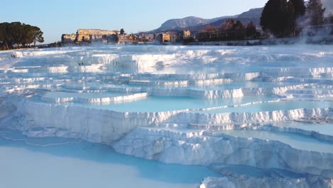 Steamy-blue-hot-springs,-mineral-waters,-forming-travertine-limestone-mineral-deposit-formations