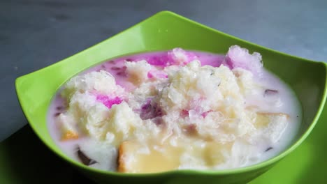 Slow motion establishing shot of a traditional cold sweet Indonesian dessert Es Campur, Indonesia