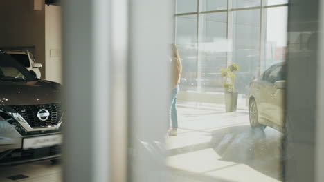 car dealership showroom with customers and sales representatives