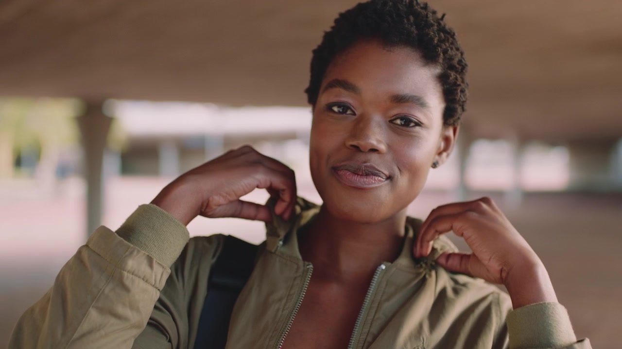 Young Woman Taking Off Her Hood in Urban Setting