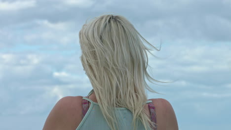 Back-view-of-lonely-blond-woman-looking-away-in-the-future