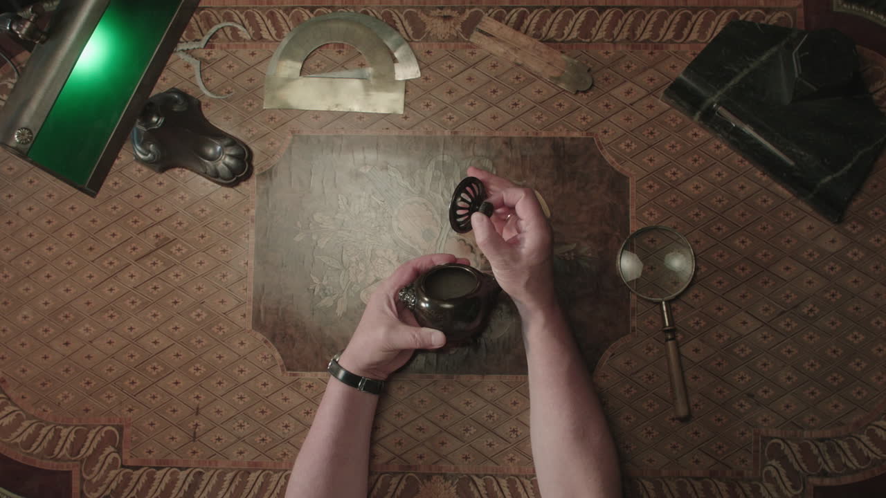 An older man evaluates an old item