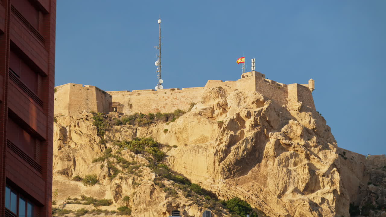 The Castillo de Santa Barbara crowns a rugged limestone outcrop, its bastions squared against a cloudless sky