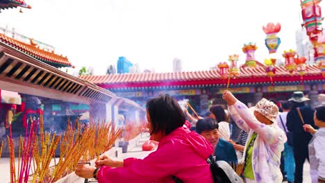 people offering incense at hong kong temple