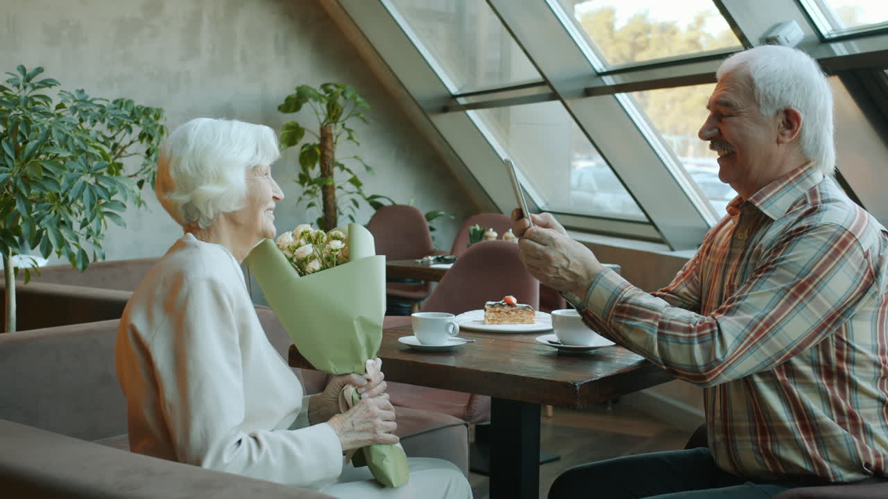 Elderly Couple Celebrating in a Cafe