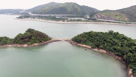 Hong-Kong-bay,-with-a-strip-of-sand-connecting-small-natural-islands,-Aerial-view