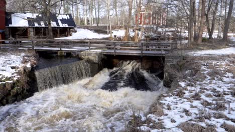 White-foamed-rushing-water-exiting-a-water-gate-belonging-to-an-old-abandon-ironworks